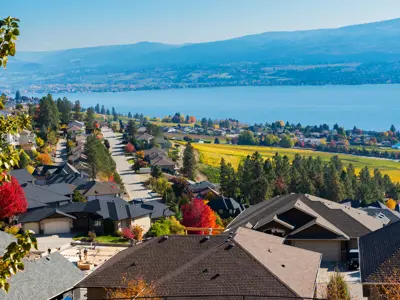 Homes will lake views on a tree-tree lined street in fall